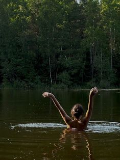 a woman swimming in the middle of a lake