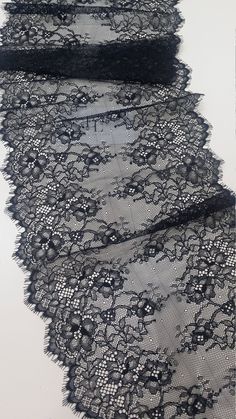 an image of black lace with flowers on it