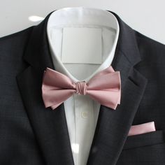 Classy and formal pre-tied and adjustable satin double-deck bow ties for your next formal event. Matches great with suits and tuxedos. Color: Dusty Rose Pink Material: Satin Polyester Adult Pre-Tied Bow Tie: approx. 4.75 inch width by 2.5 inch height Necksize 11.5 inches - 20 inches Metal clasp for secure and comfortable wear. Matching Pocket Square: approx. 9 inches by 9 inches www.tie-mood.com Pink Ties For Men, Dusty Rose Suit Men, Dapper Suit And Tie Accessories For Wedding, Classic Fitted Bow For Groom, Classic Wedding Bow Tie And Suit Accessories, Classic Wedding Suit And Tie Accessories With Bow Tie, Wedding Ties With Satin Bow Detail, Wedding Ties With Satin Bow, Dapper Solid Color Tie For Wedding