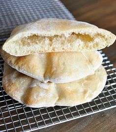 three biscuits stacked on top of each other on a cooling rack in front of a wooden table