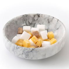 a marble bowl filled with assorted cubes of fruit