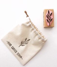 a rubber stamp with the words hand carved stamp next to it and a cloth bag