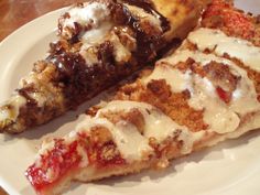 two slices of pizza sitting on top of a white plate