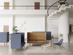 a living room filled with furniture next to a spiral stair case on the wall and floor