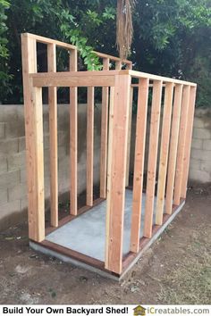 a small wooden structure in the middle of a yard