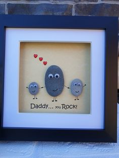 two rocks in a shadow frame with the words daddy, you rock