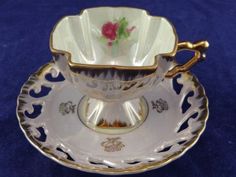 an antique tea cup and saucer on a blue background