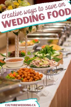 a table filled with lots of food on top of a white tablecloth covered table