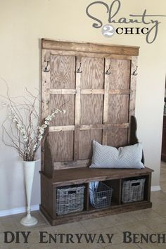 the entryway bench is made from an old door and has baskets on it for storage