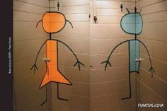 two bathroom stalls decorated with stick figures