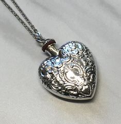 This is a Sterling silver hollow pendant necklace.  The top screws off and the cavity can hold perfume, ashes, sand, essential oil or anything that you want close to you.  It measures 40mm in height and 30mm wide and weighs approx. 12.5 grams.  Comes on a silver plated cable chain that you can pick the length .  Free shipping through USPS First class mail. Silver Etched Necklace For Valentine's Day, Valentine's Day Silver Etched Necklace, Silver Heart Locket Necklace Spiritual Style, Spiritual Silver Heart Pendant Locket Necklace, Spiritual Silver Locket Necklace For Memorial, Spiritual Silver Locket Necklace For Anniversary, Heart Perfume, Essential Oil Necklace, Funky Jewellery