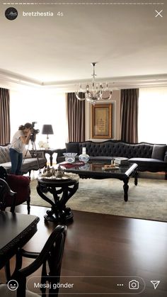 a living room filled with furniture and a chandelier