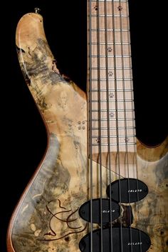 an electric bass guitar that is made out of wood