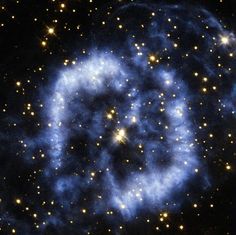 a blue spiral shaped object surrounded by stars