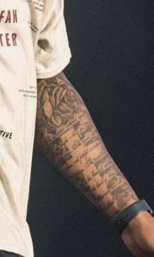 a man with tattoos on his arm and arms