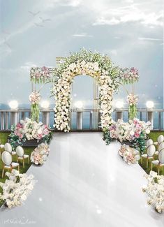 an outdoor wedding setup with white flowers and greenery on the side of the aisle