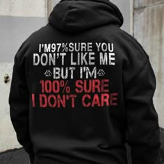 a man wearing a black hoodie that says i'm 97 % sure you don't like me but i'm 100 % sure i do not care