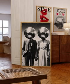 there are two posters on the wall in this living room, one has disco balls over his head