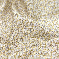 the fabric is yellow and white with small flowers on it