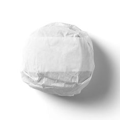 a white paper ball with some sort of wrapper on it's side, against a white background