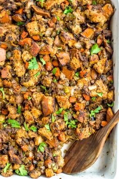 a casserole dish filled with stuffing and vegetables