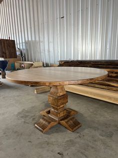 a table made out of wood sitting on top of a cement floor next to wooden planks