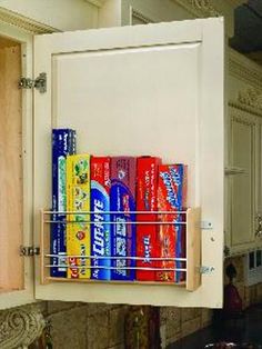 a kitchen cabinet filled with lots of different types of cans and cans on the door