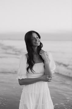 black and white photo of woman smiling on the beach