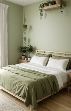 a bedroom with green walls and white bedding