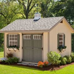 a small shed sitting in the middle of a yard