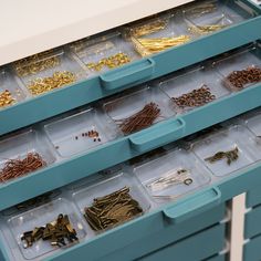 the drawers are filled with lots of different types of beads and other things to make it look like they have been organized