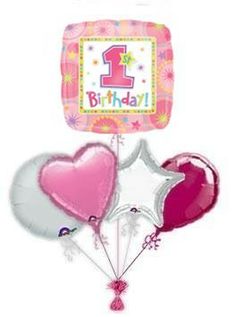 the 1st birthday balloon bouquet is pink, silver and heart - shaped balloons with stars on them