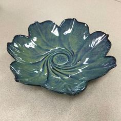 a green ceramic bowl sitting on top of a counter