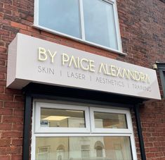 a brick building with a sign that says by pace alexandria skin laser and aesthetics training