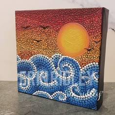 a painting made out of plastic bottles with the word ocean painted on it's side