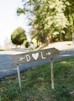 a wooden sign with the word dol painted on it in front of a street