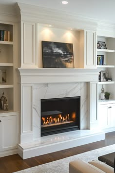 a fireplace in a living room with built - in bookcases