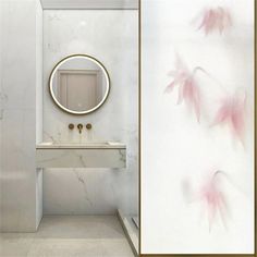 a bathroom with marble walls and flooring has pink flowers painted on the wall next to it