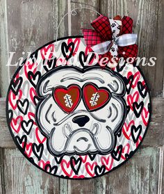 a door hanger decorated with hearts and a bulldog's face