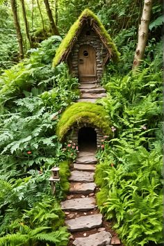 a small house in the middle of a forest with moss growing on it's roof