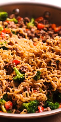 a pan filled with noodles and vegetables on top of a table