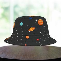 Get ready for an out-of-this-world adventure with our Space Cartoon Planets Bucket Hat - Perfect for stargazers and space enthusiasts alike! Looking for a unique and quirky bucket hat to add a touch of fun to your wardrobe? Check out this Space Cartoon Planets Bucket Hat on Etsy! This hat features a cute and colorful pattern of planets, stars, and other astronomy-themed elements that are sure to make you stand out from the crowd. Whether you're a nerd, geek, or just someone who loves outer space, this hat is the perfect accessory for you. The retro design adds a touch of nostalgia, while the high-quality materials ensure that it's comfortable and durable. So why wait? Head over to Etsy now and grab this fun and quirky hat before it's gone! First, it protected fishermen from rain in the 190 Bucket Hat Painting, Cartoon Planets, Cute Planets, Astronomy Planets, Space Cartoon, Space Costumes, Nerd Geek, Modern Wardrobe, Outer Space