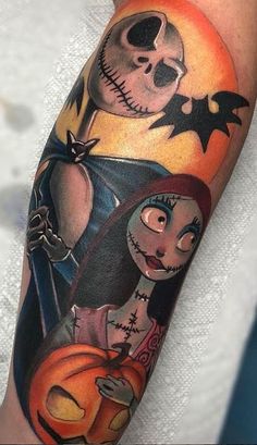 a person with a halloween themed tattoo on their arm