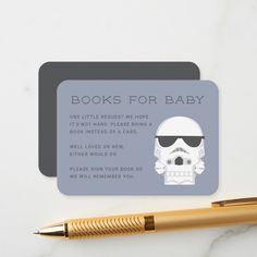 a business card with a skull on it and a pen sitting next to it that says books for baby