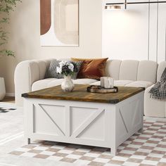 a living room with a white couch and coffee table