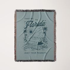 a blue florida beach towel hanging on a wall