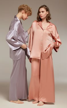 Immerse yourself in sumptuous comfort with our satin pajamas set, an elegant addition to your sleepwear repertoire. Artfully crafted from soft, breathable satin, this boutique-produced, limited-edition set marries style and comfort with finesse. The sophisticated button-up nightshirt exhibits a notch collar and voluminous sleeves, complemented by the wide-leg trousers with a button-front, pleated design and a semi-elastic waistband. This design-centric ensemble, perfect for restful nights and la Satin Night Suits, Satin Pajamas Set, Chic Loungewear, Bridal Sleepwear, Night Suit For Women, Satin Pyjama, Stylish Pajamas, Sleepwear Women Pajamas, Stylish Loungewear