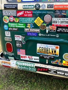 the back end of an old car covered in stickers