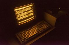 an old computer sitting on top of a desk with a keyboard and mouse in front of it