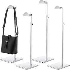 three metal stands with two bags on them